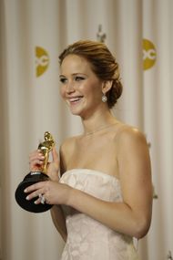 Jennifer Lawrence with her Oscar for Silver Linings Playbook (Image via Getty)
